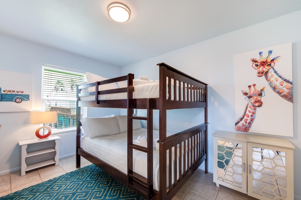 Your little ones will love this cheerful bedroom with sturdy bunk beds and playful giraffe artwork creating sweet dreams.