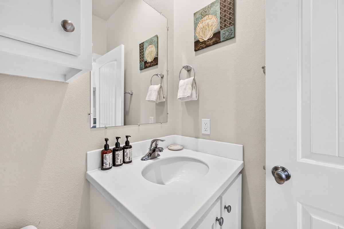 Freshen up in your private bathroom, featuring a bright vanity, modern fixtures, and coastal-inspired décor.
