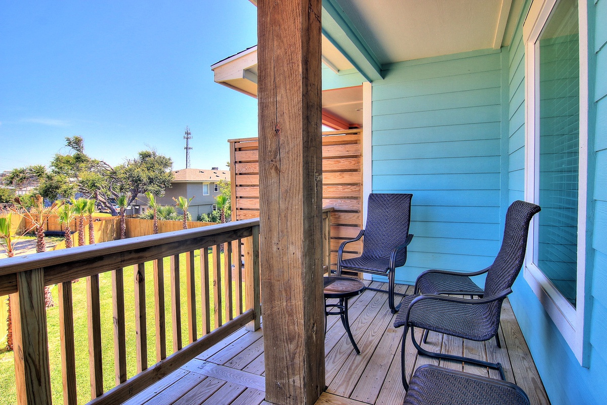 Your private balcony offers comfortable seating where you can unwind while enjoying peaceful neighborhood views and warm coastal sunshine.
