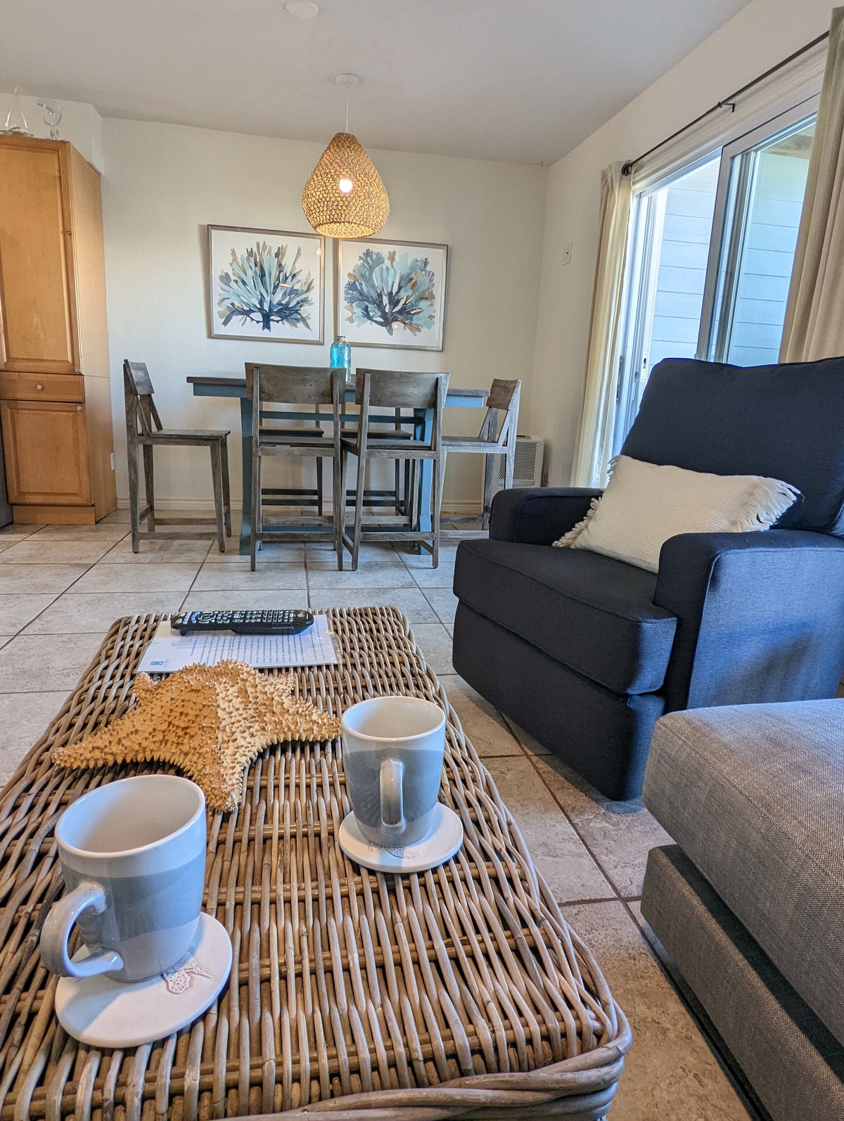 Relax in your thoughtfully designed living space where coastal charm meets modern comfort, complete with cozy seating and charming dining nook.