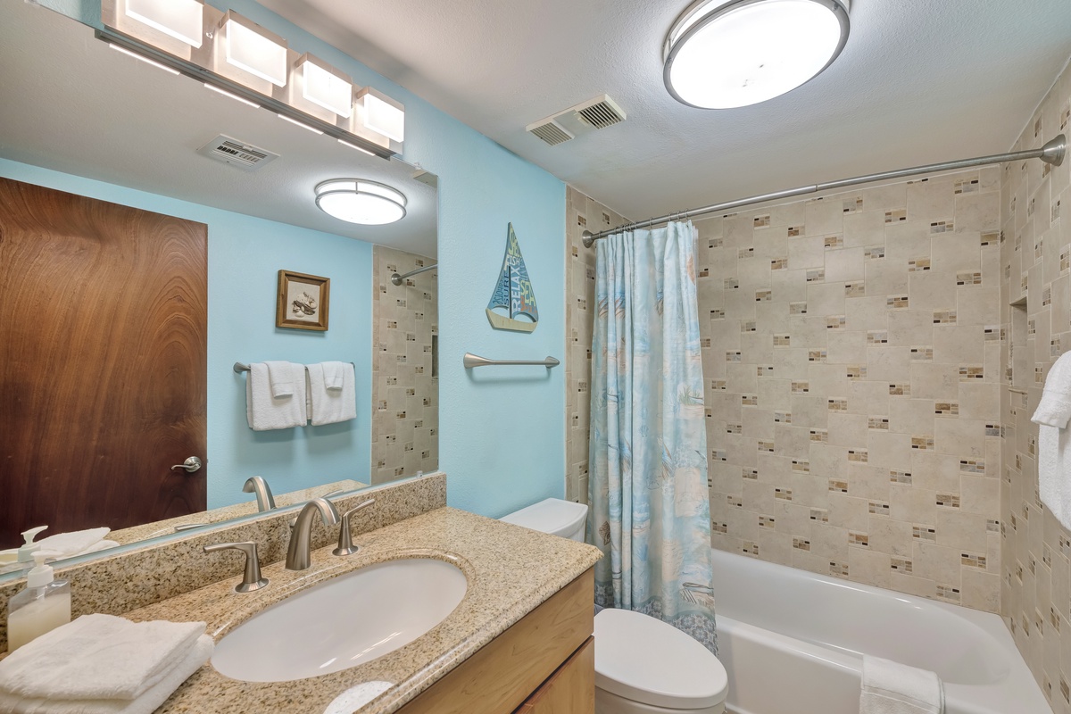 Refresh in your coastal-themed bathroom with granite countertops, decorative tiles, and nautical touches that create a serene spa-like retreat.