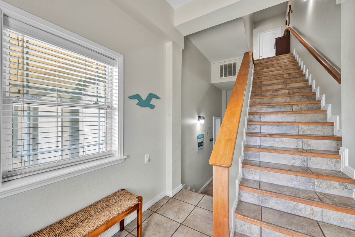 You'll love the peaceful entryway with coastal touches and natural light streaming through the blinds, setting a calm tone for your stay.