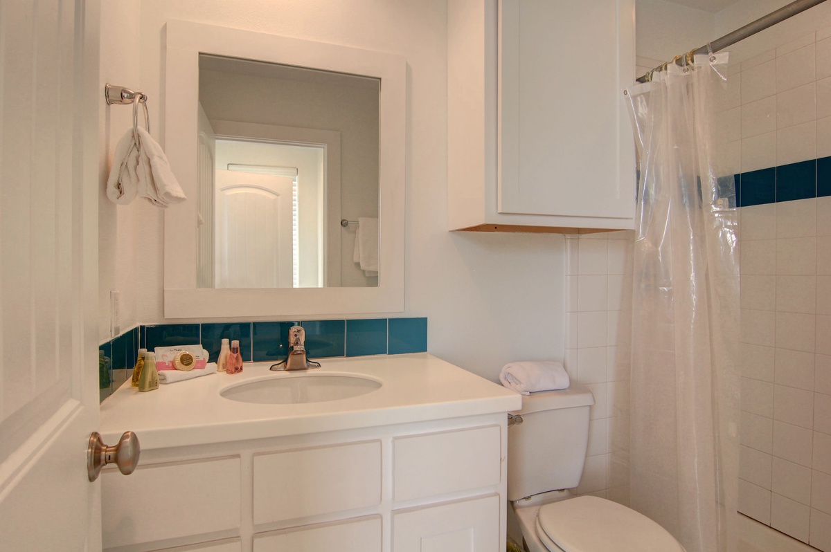 Step into your pristine bathroom featuring a spacious vanity and refreshing shower—everything you need for a comfortable stay.