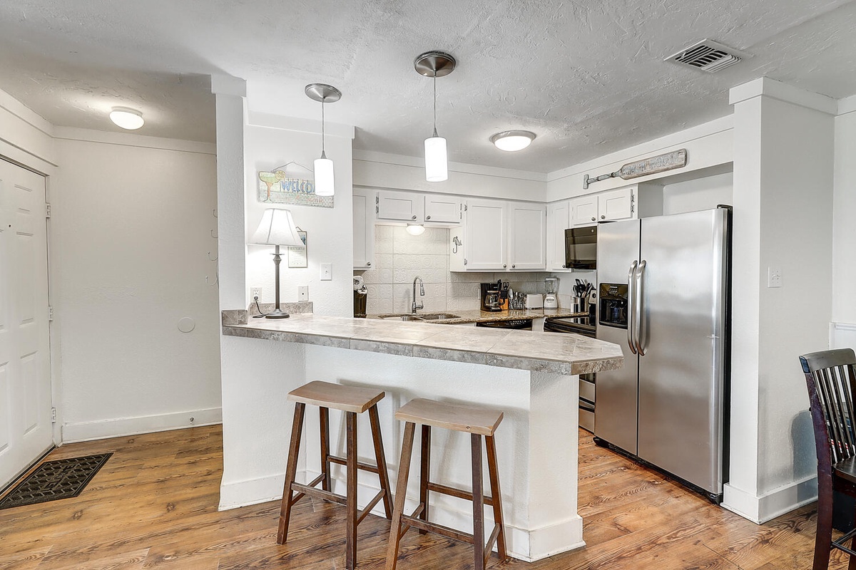 Your modern kitchen features granite counters, stainless appliances, and a breakfast bar where you can enjoy morning coffee.
