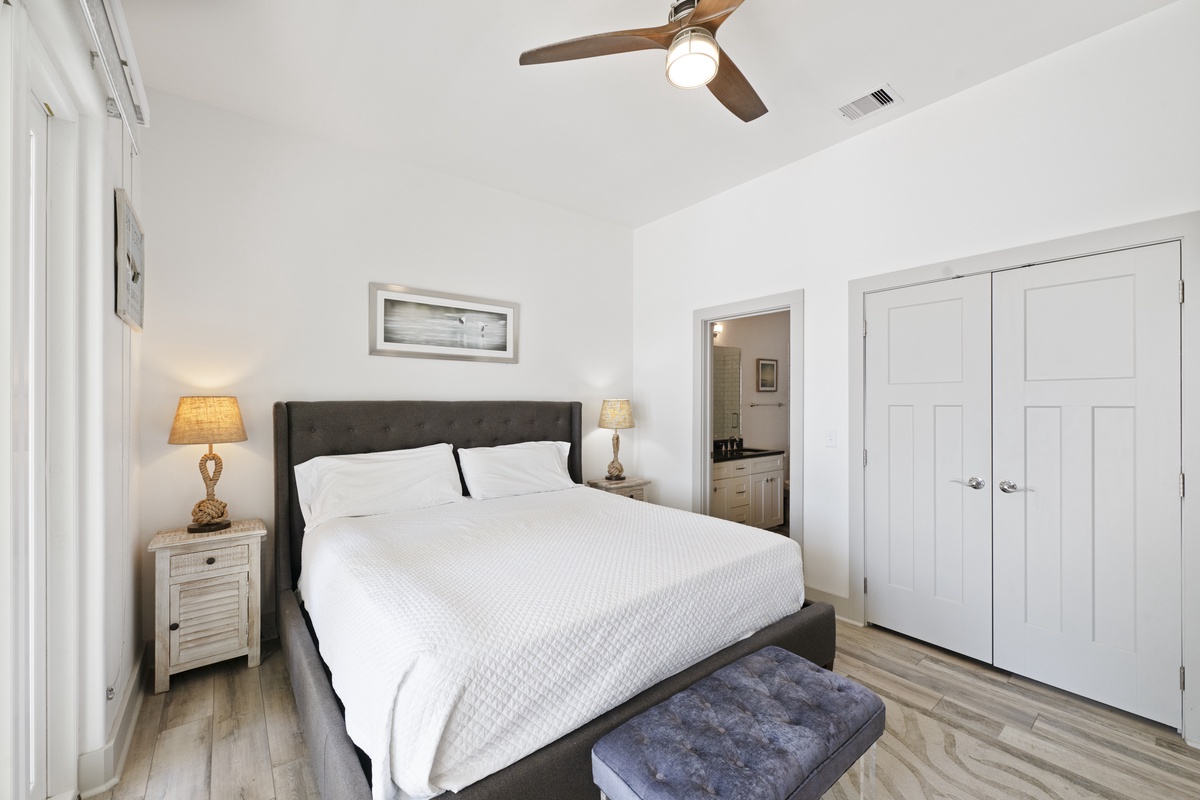 Drift off in this serene bedroom where crisp white linens meet warm coastal touches, creating your perfect retreat.