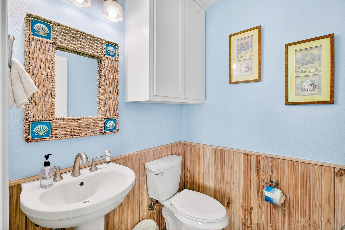Refresh in your coastal-themed powder room with charming nautical touches and soothing blue walls that make every visit feel like a seaside escape.