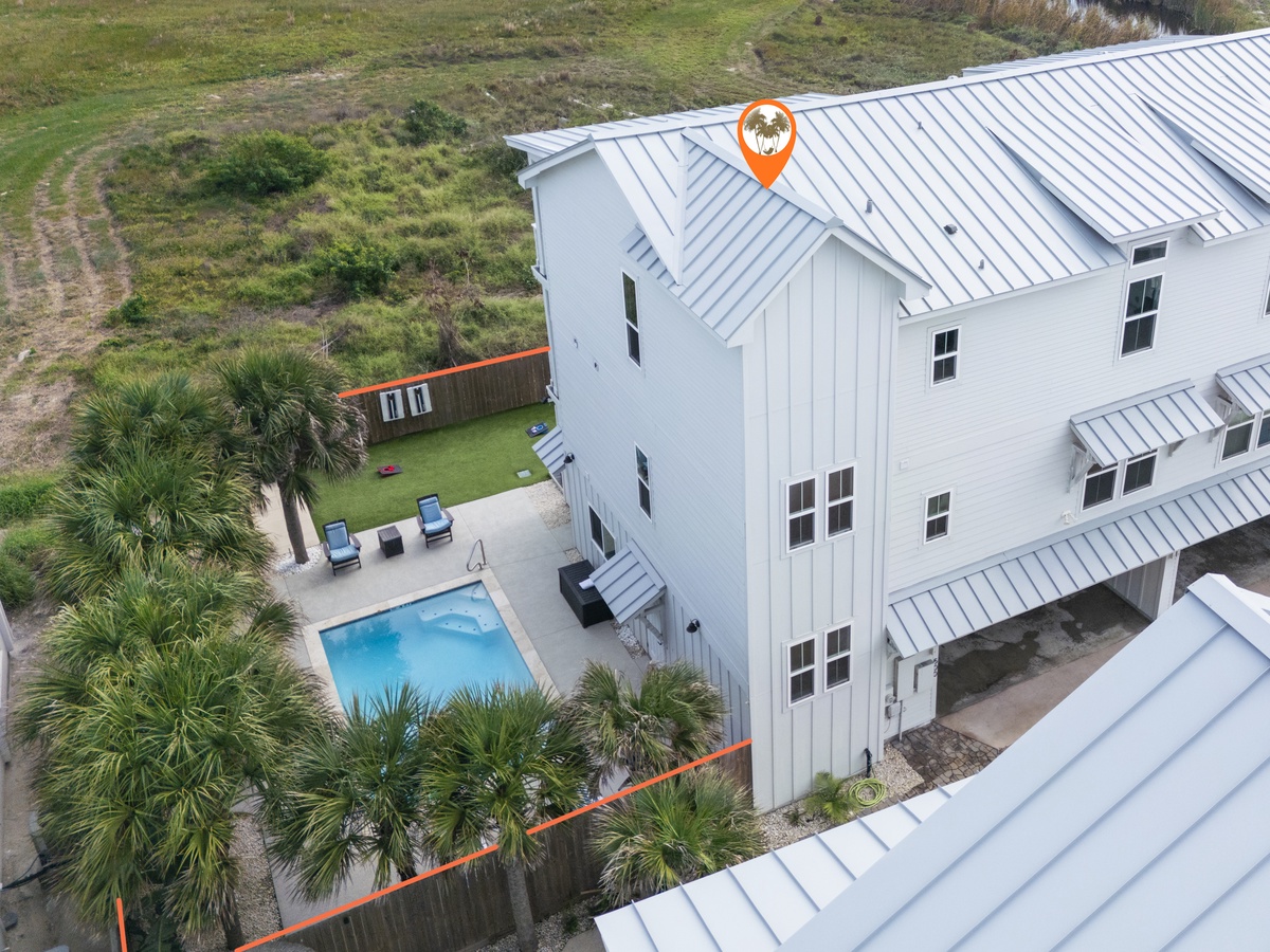 Modern coastal home with private pool and tropical landscaping in a serene natural setting.