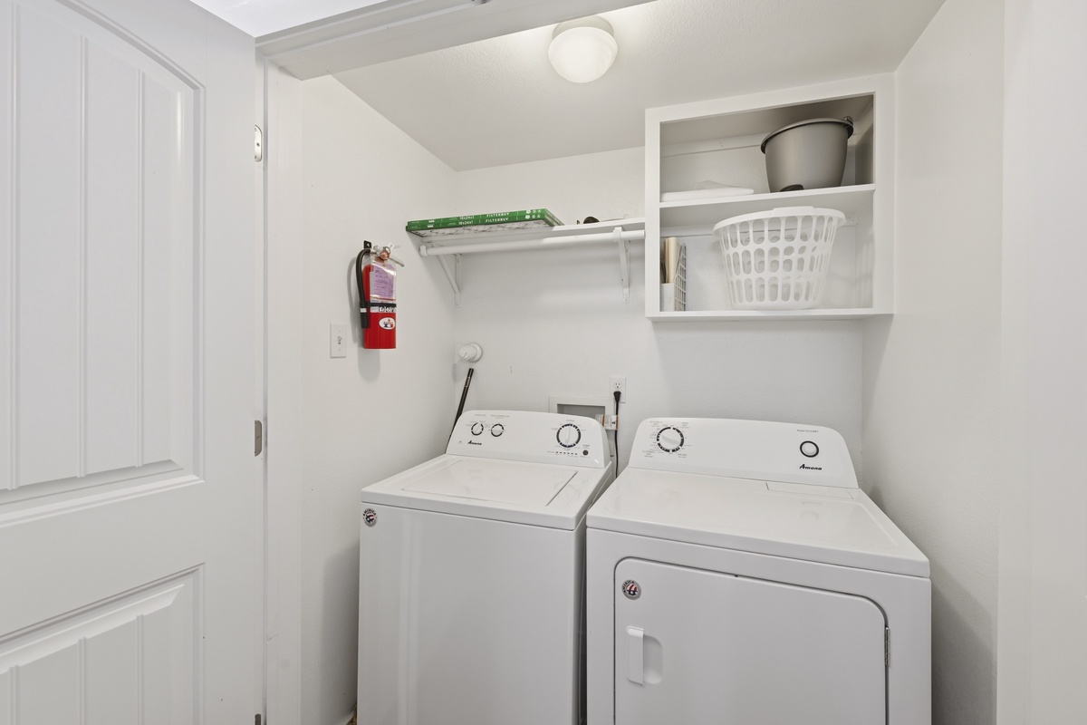 Your laundry stays effortless with this dedicated space equipped with a full-sized washer and dryer, plus handy storage for all your essentials.