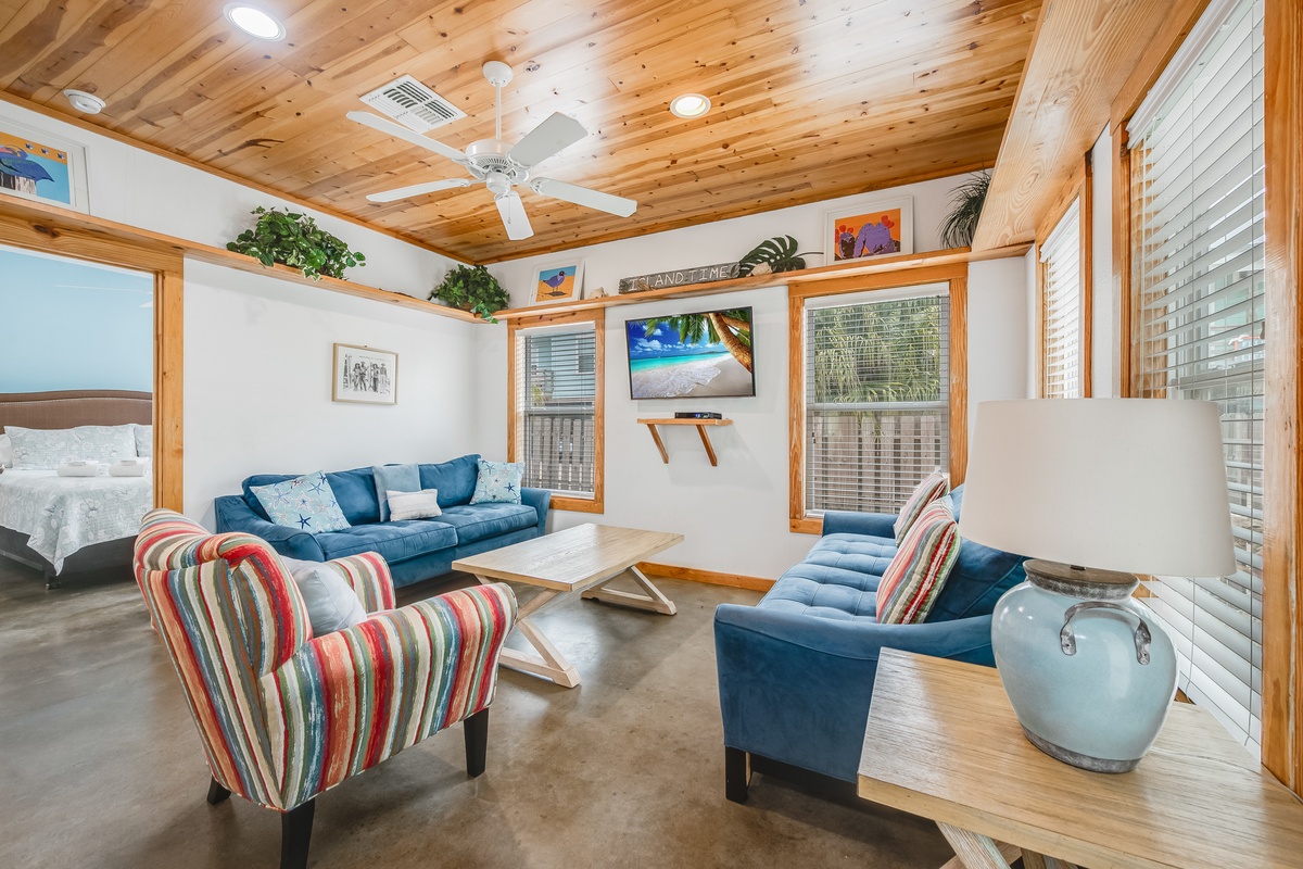 Your coastal retreat features warm wood ceilings, comfortable seating, and peaceful island vibes perfect for unwinding after beach adventures.