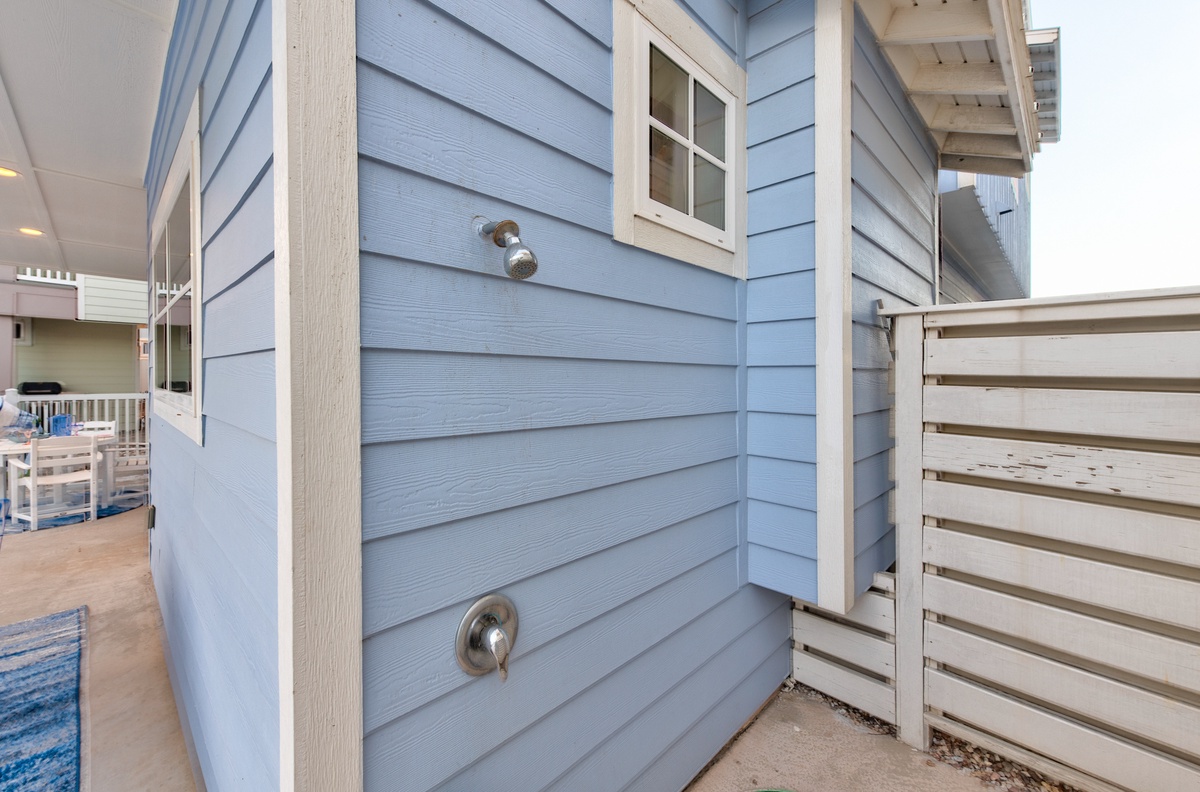 Rinse off beach sand in your private outdoor shower with coastal charm.