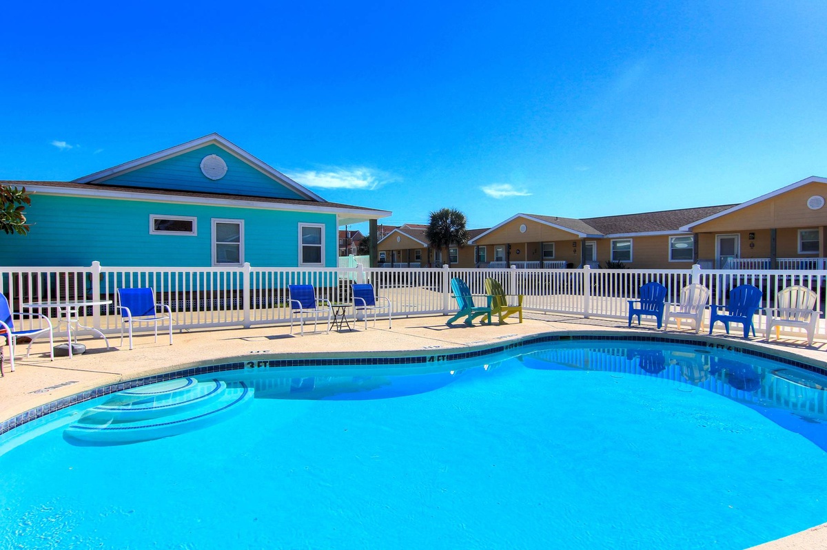 Dive into your private poolside paradise, surrounded by colorful beach cottages and plenty of lounge chairs for soaking up the Florida sunshine.