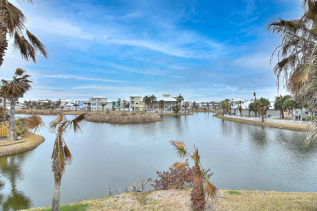 Peaceful waterfront community with palm-lined shores and charming homes scattered around the tranquil lagoon.