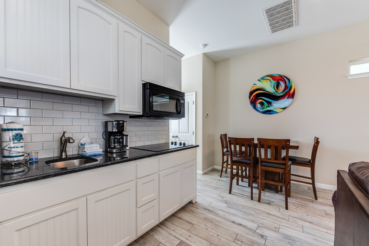 Your fully equipped kitchen features modern appliances and flows seamlessly into the dining area for memorable meals together.