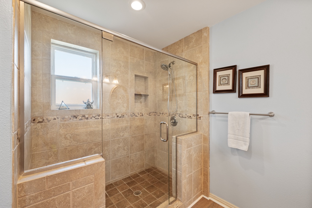 Step into your elegant tiled shower with built-in seating and modern fixtures for refreshing mornings.