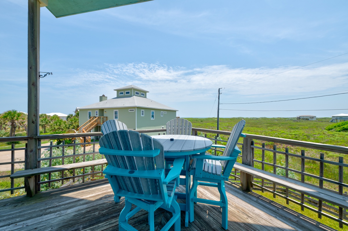 Picture yourself enjoying morning coffee at this breezy deck table, where coastal breezes meet expansive views of the surrounding natural landscape. Your perfect coastal getaway starts right here.