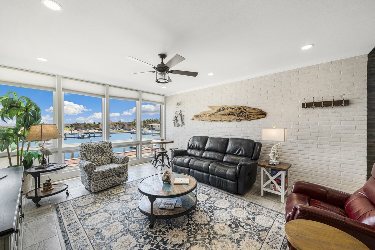 Relax in your waterfront living room with panoramic marina views and coastal decor that brings the nautical spirit indoors.