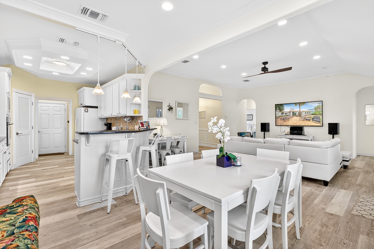 Step into this bright open-concept space where your kitchen, dining, and living areas flow seamlessly together, perfect for gathering with loved ones.
