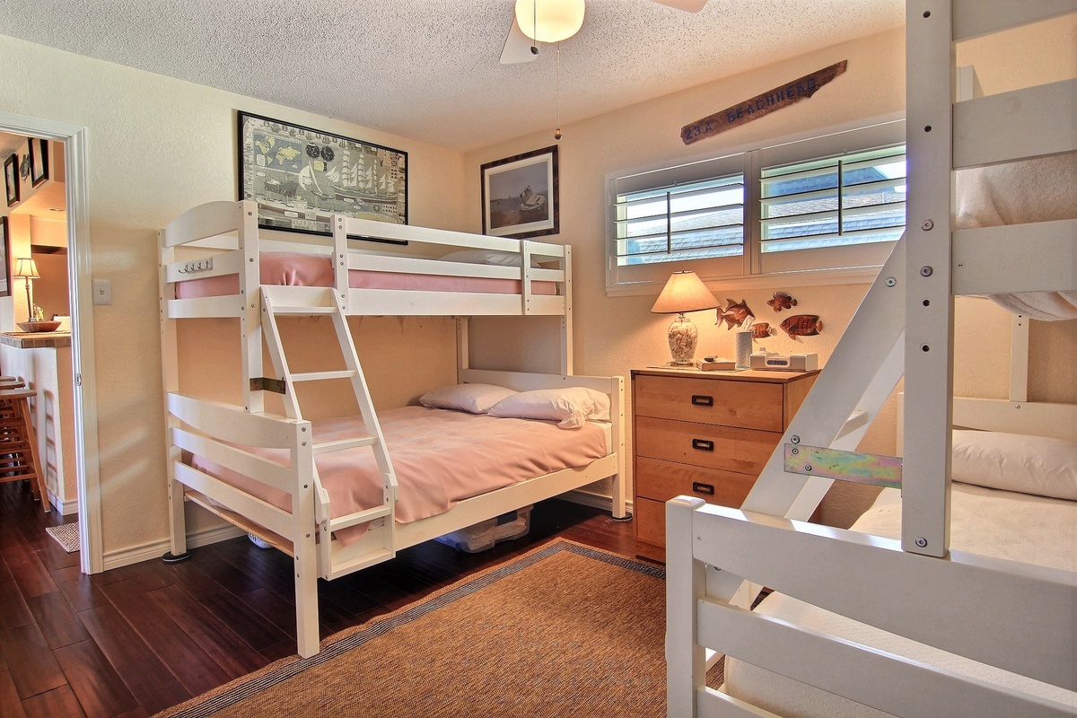 Your cozy bunk room sleeps the whole crew, complete with reading lamps and beach-themed touches for seaside dreams.