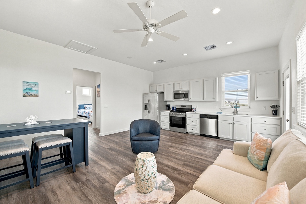 Open space to cook in your full kitchen, relax on the plush couch, and enjoy the comfort of modern appliances and coastal-inspired touches that make you feel right at home.