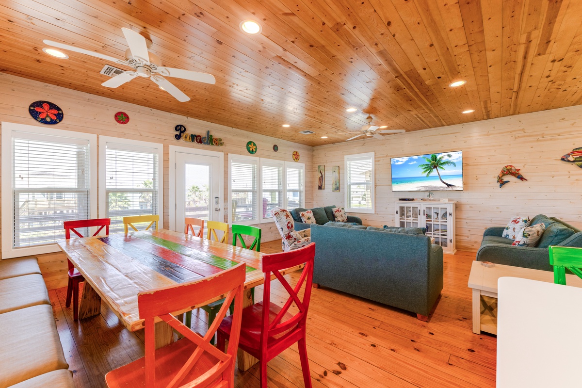 Relax in your vibrant island-themed living space with colorful dining chairs, cozy sectional seating, and tropical decor that brings paradise indoors.
