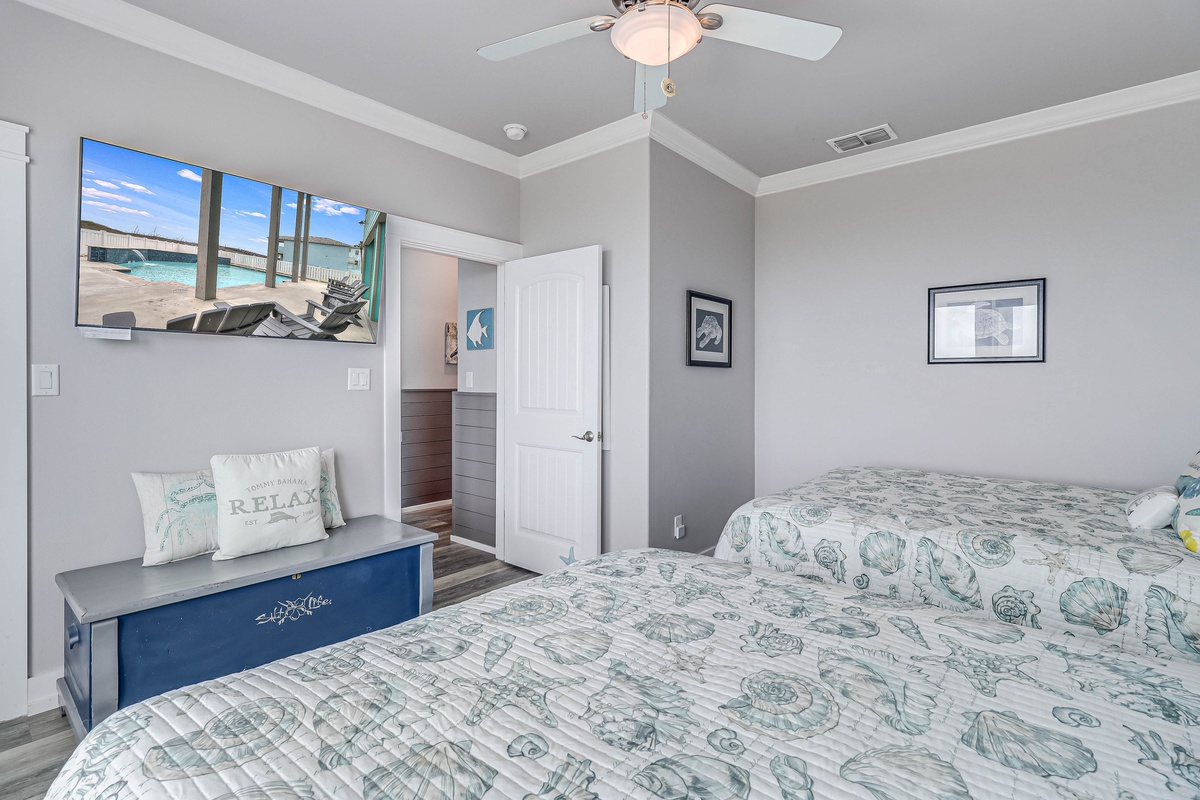Drift into coastal dreams in this peaceful bedroom, where ocean-themed decor and your smart TV create the perfect retreat.