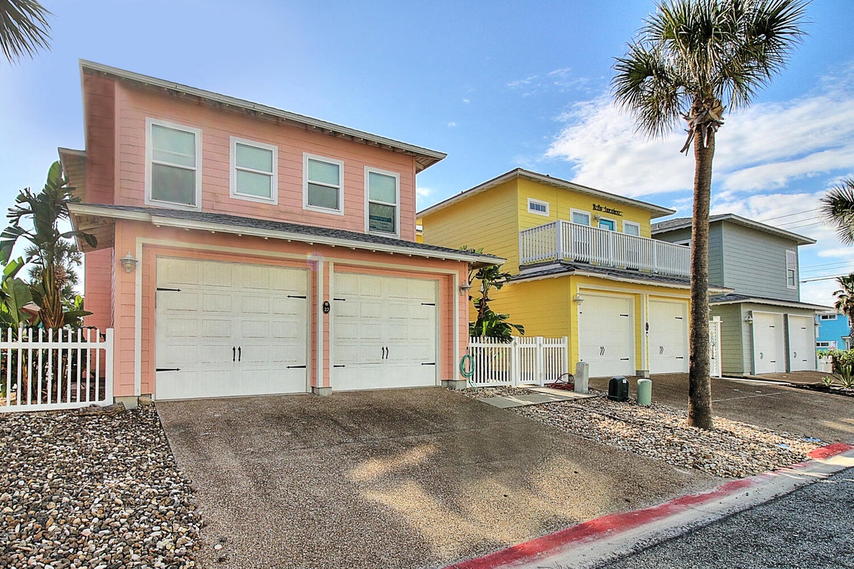 Colorful coastal homes with tropical palms create a vibrant beachside neighborhood setting for your getaway.