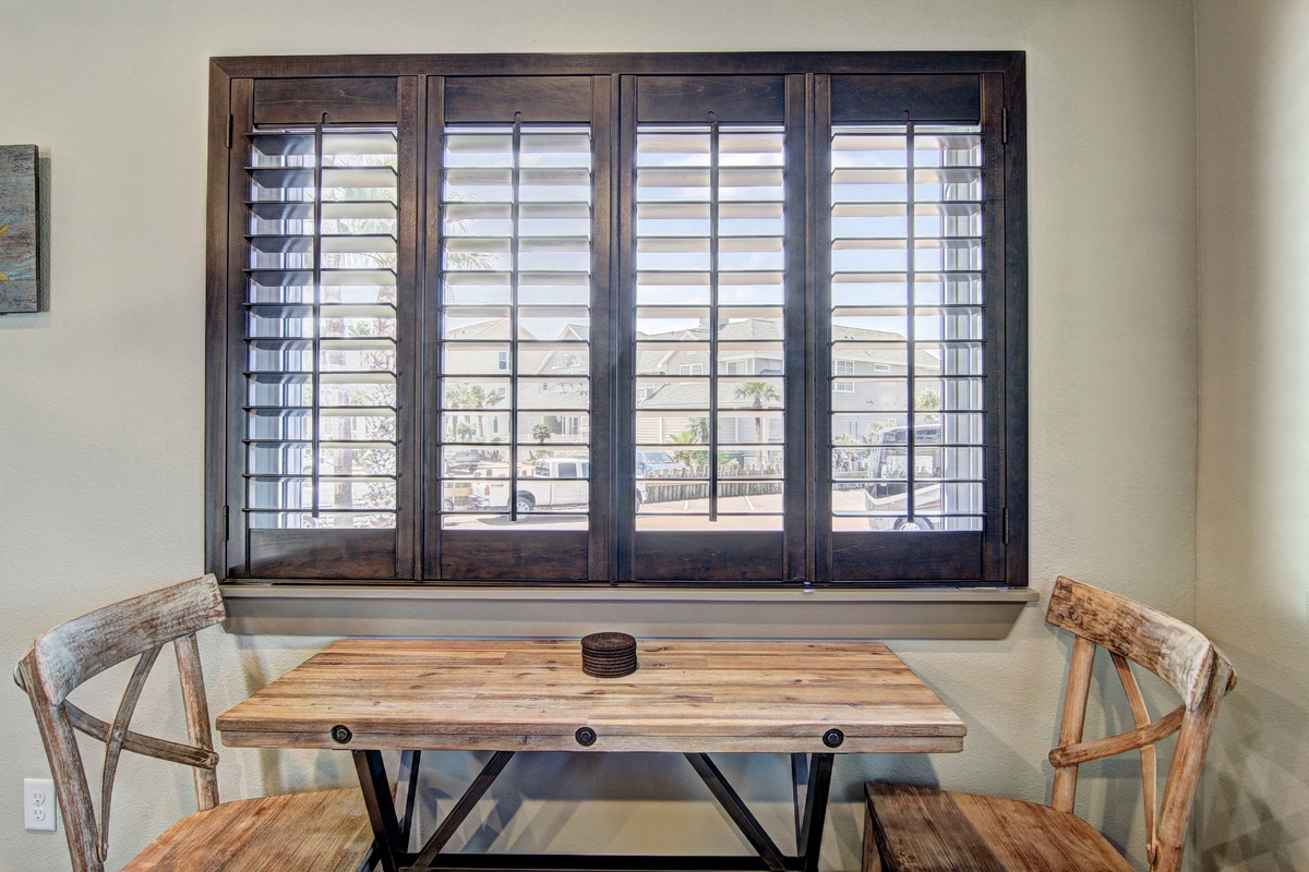 Settle into your private dining nook with rustic charm, where wooden shutters frame city views and handcrafted furniture creates the perfect spot for morning coffee.