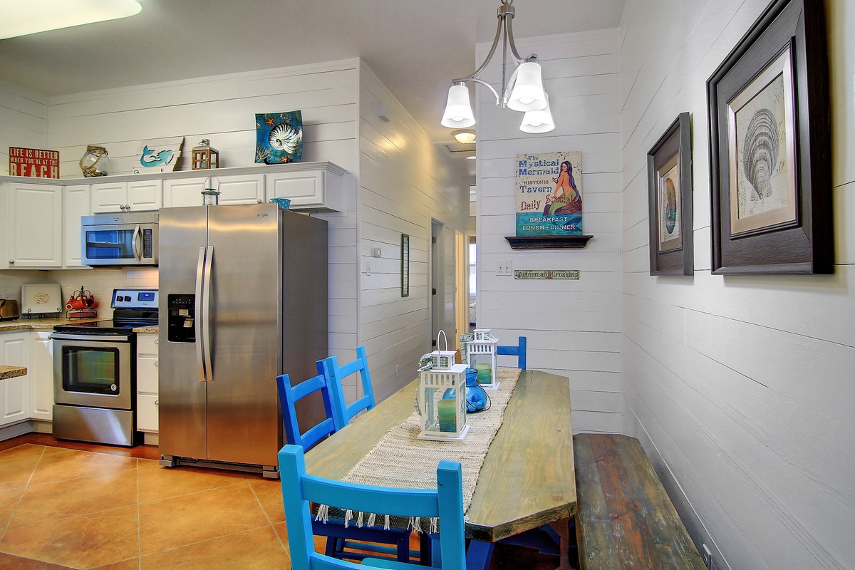 You'll love preparing meals in your fully equipped kitchen with stainless steel appliances and gathering around your charming blue dining table.