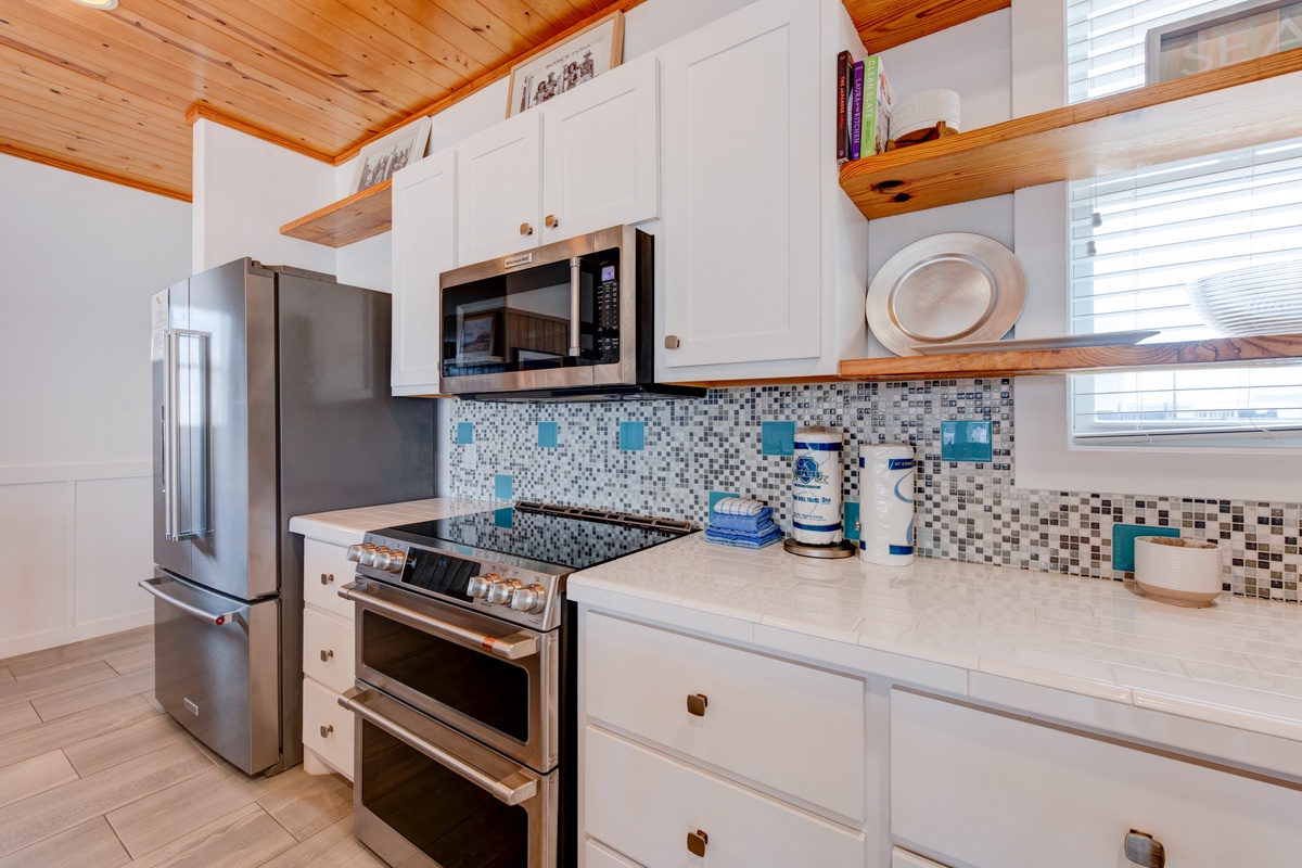 Your fully equipped kitchen features modern appliances and charming wood beam details, perfect for preparing meals during your stay.