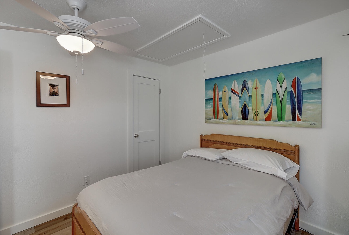 Rest peacefully in your cozy bedroom, where beach-themed artwork and soft linens create the perfect coastal retreat atmosphere.
