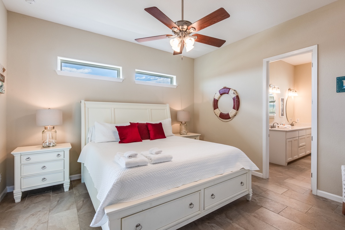 Unwind in your coastal-themed bedroom with crisp white linens, nautical touches, and your own ensuite bathroom for ultimate comfort.