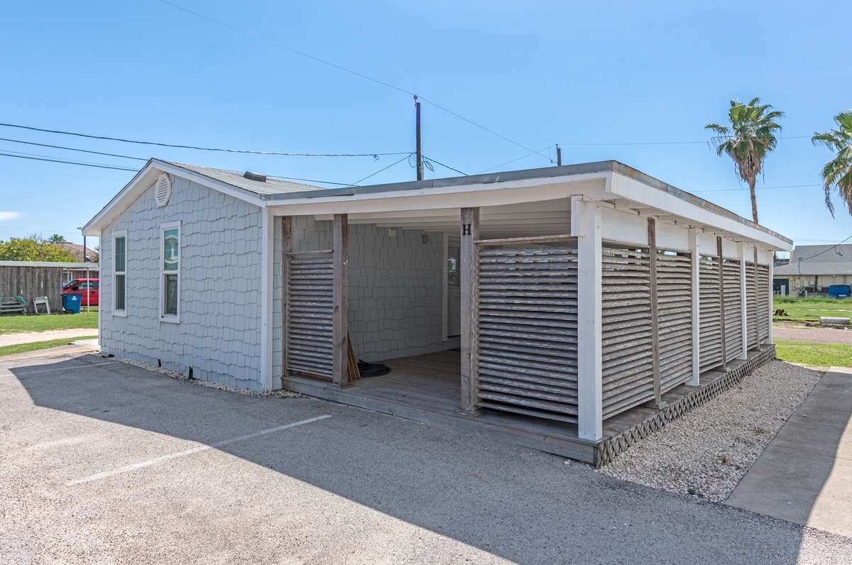 Single-story vacation home with covered parking and coastal charm in a peaceful neighborhood setting.