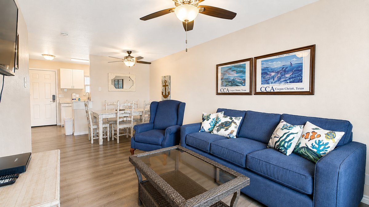 Relax in your bright coastal living room with comfortable seating and charming nautical touches throughout.