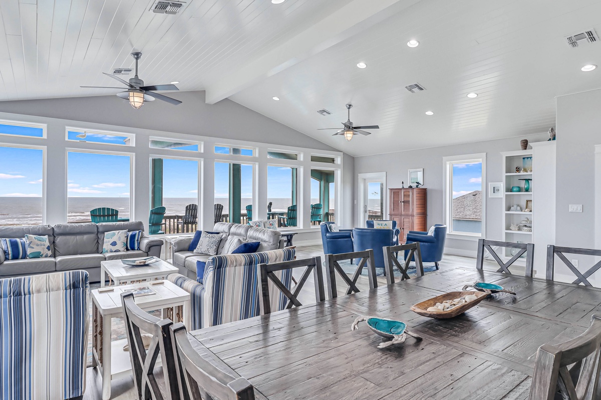 Relax in your bright, airy living space with panoramic ocean views through floor-to-ceiling windows and coastal-inspired décor.