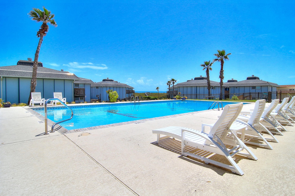 Dive into crystal-clear waters surrounded by swaying palms, then unwind on loungers under endless blue skies in your private poolside paradise.