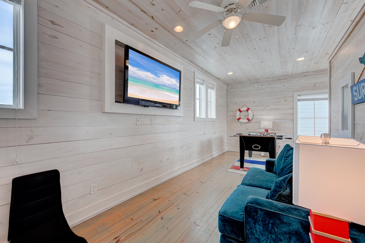 Unwind in your bright entertainment space with coastal charm, featuring plush seating and a large TV for movie nights.