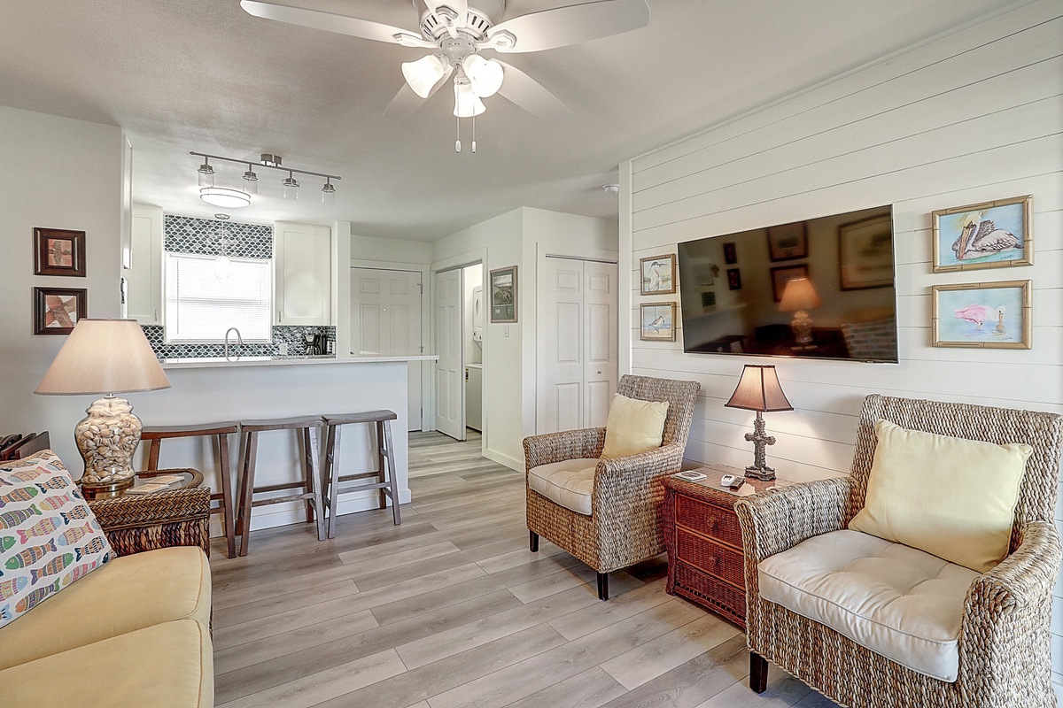 Unwind in your stylish coastal retreat where shiplap walls and wicker furniture create beachy charm, perfect for relaxing evenings.