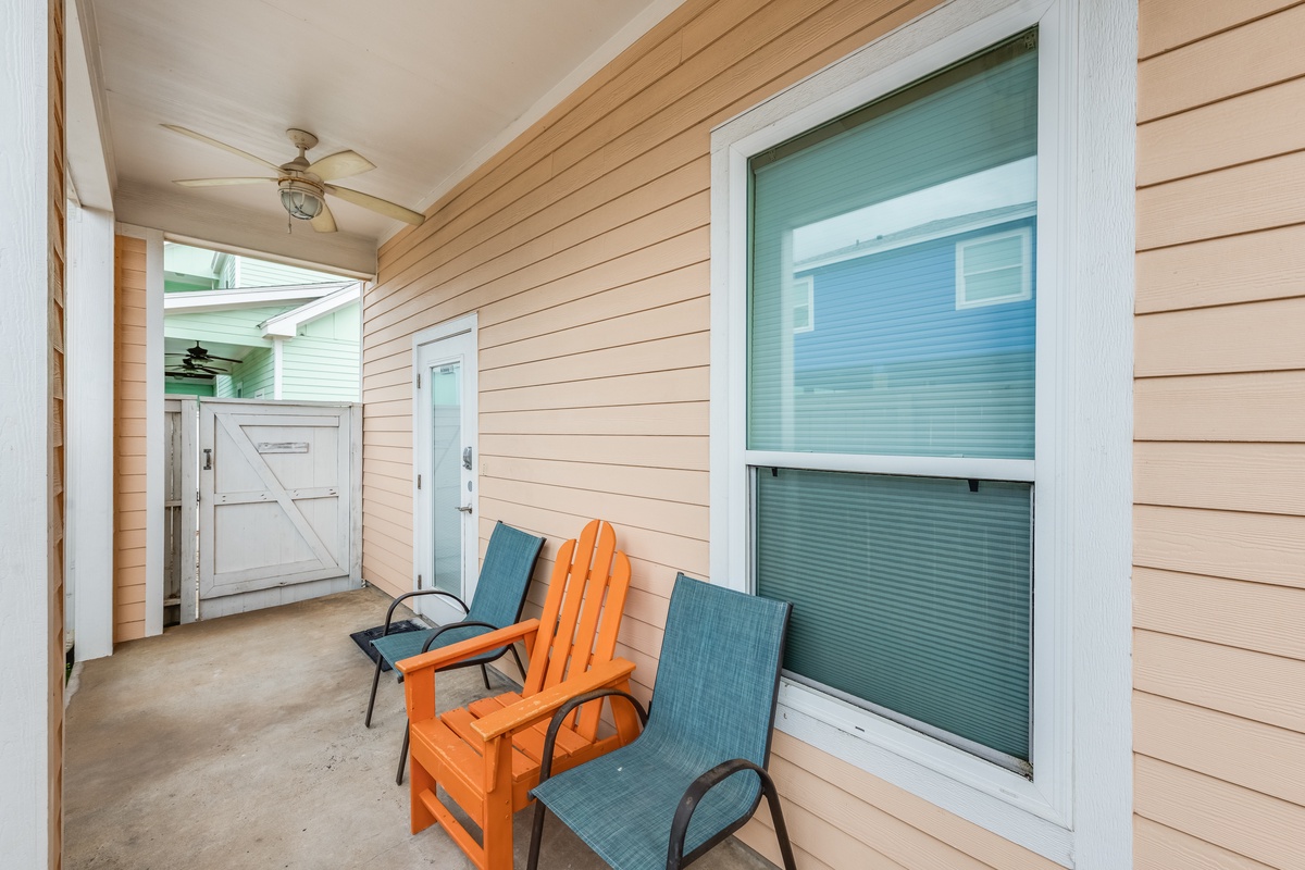 Relax on your private covered porch with comfortable seating and gentle ceiling fan breezes.