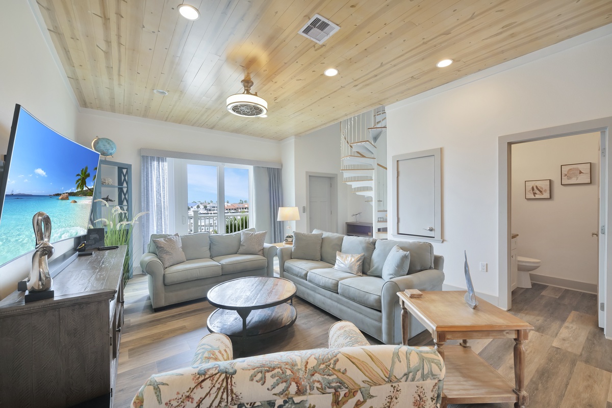 Relax in your spacious living room with vaulted wood ceilings, plush sectional seating, and large TV for movie nights together.