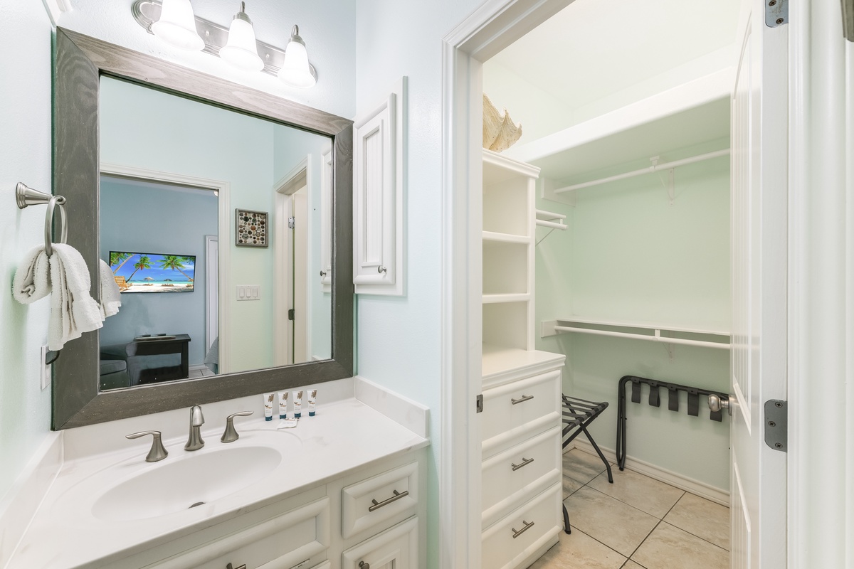 Freshen up in your elegant bathroom with marble countertops and modern fixtures, plus convenient walk-in closet storage.