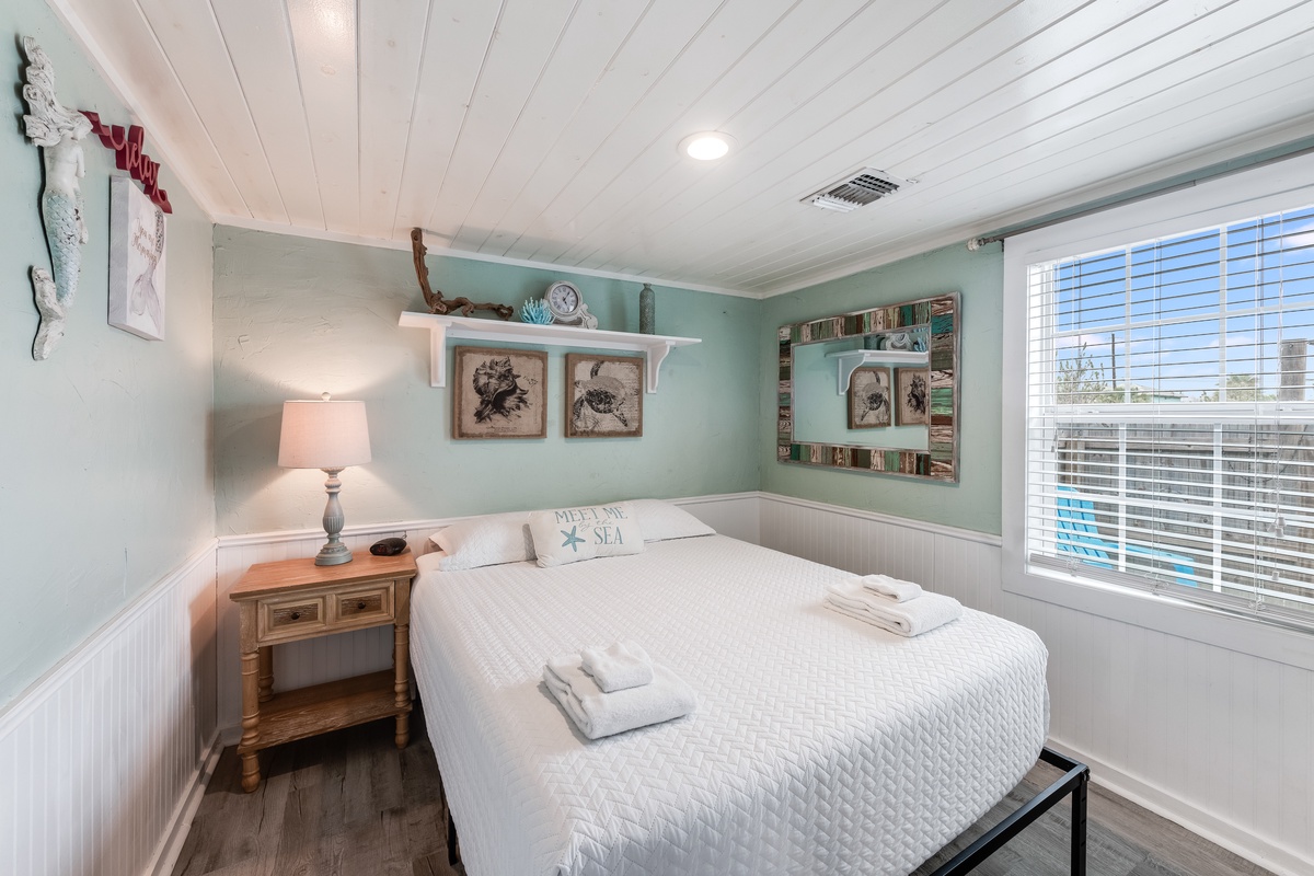 Drift into peaceful slumber in your charming coastal bedroom, where soft seafoam walls and crisp white linens create the perfect seaside sanctuary.