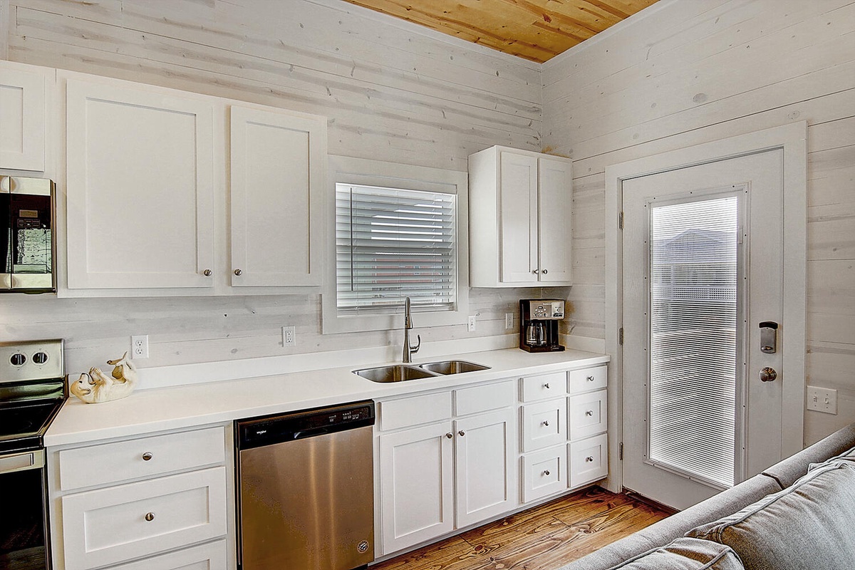 Your bright kitchen features clean white cabinets, stainless appliances, and charming wood accents for your cooking adventures.