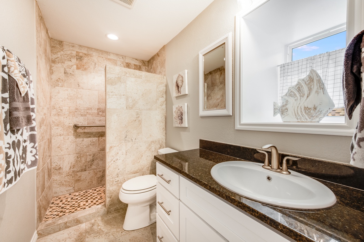 Your spa-inspired bathroom features luxurious travertine tile, a spacious walk-in shower, and elegant granite countertops for ultimate relaxation.