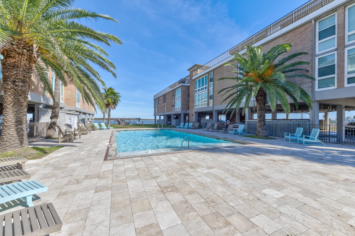 Dive into crystal-clear waters surrounded by swaying palms and modern comfort, with the sparkling ocean just steps away from your tropical oasis.