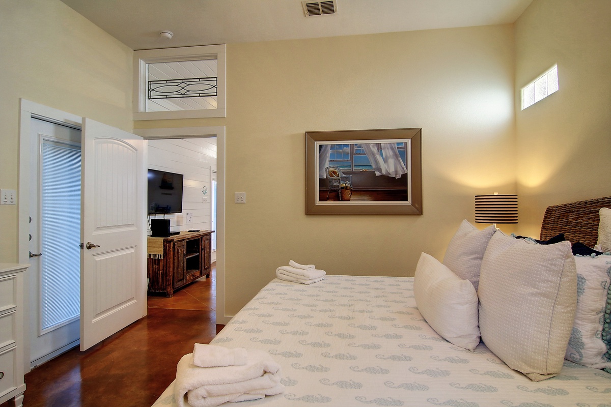 Sink into crisp linens and plush pillows in your serene bedroom, where warm lighting and thoughtful touches create the perfect retreat.