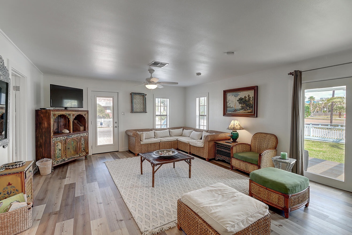 Unwind in your spacious living room with comfortable wicker seating, perfect for gathering with loved ones.