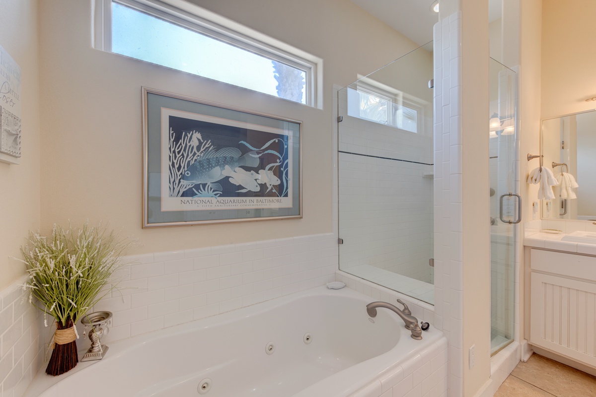 Unwind in your spa-like bathroom with a luxurious jetted tub and glass-enclosed shower, perfectly designed for ultimate relaxation.