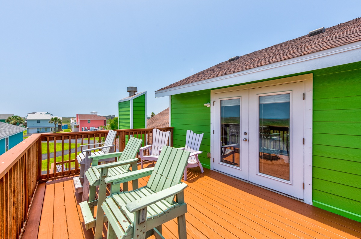 Relax on your private deck with Adirondack chairs overlooking the colorful neighborhood, perfect for morning coffee or sunset drinks.