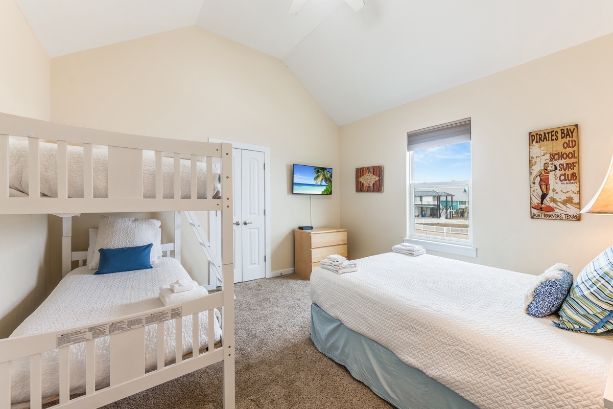 Your family bedroom offers coastal comfort with a queen bed and bunk bed, perfect for seaside adventures.