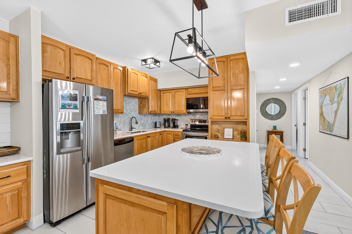 Your gourmet kitchen features gleaming countertops, modern appliances, and abundant cabinet space—perfect for preparing family meals or morning coffee before heading out to explore.